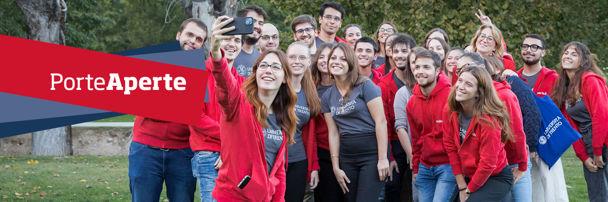 young people smiling for a group selfie